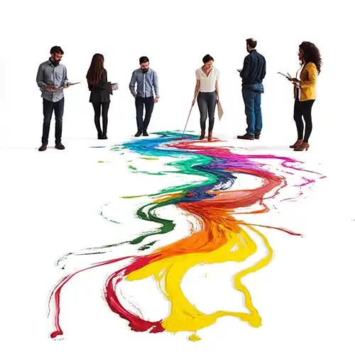 A team stands behind several trails colorful trails of spilled paint